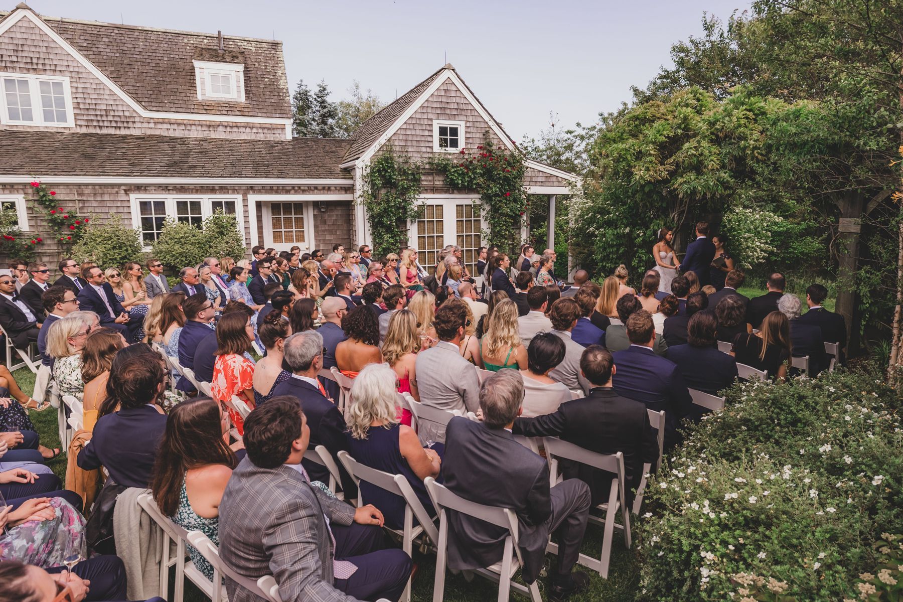 Wedding ceremony on the lawn of a cedar-shingled house on Nantucket