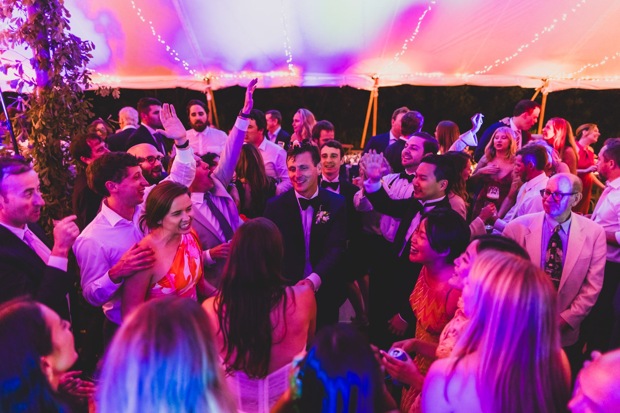 Packed dance floor under a Nantucket wedding tent